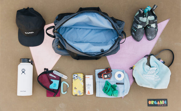 Load out photo that shows the main compartment of the OSCA wide open and various climbing gear laid out around it.